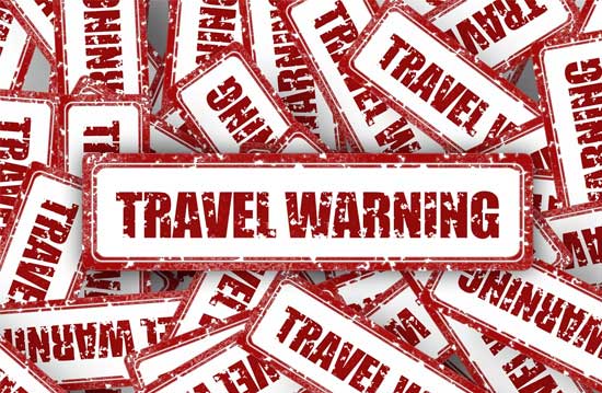 a banner with the words "travel warning"