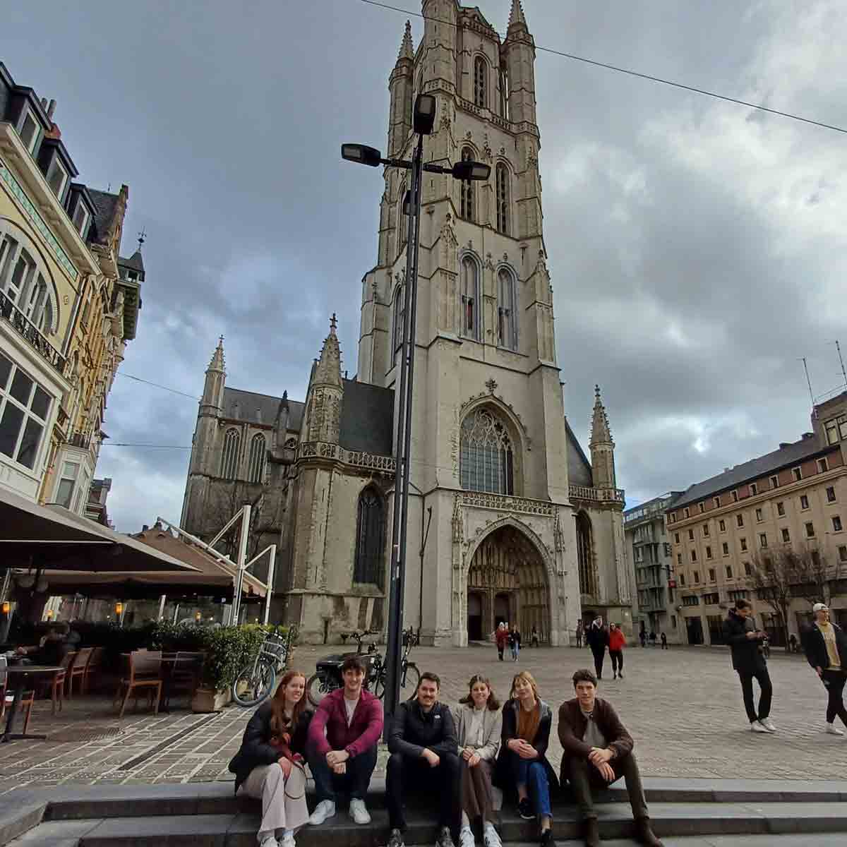 students posing for a picture outside of a cathedral