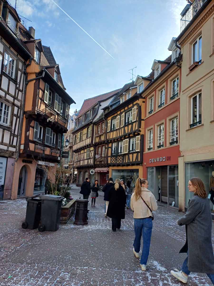 students walking in a corridor in a European village