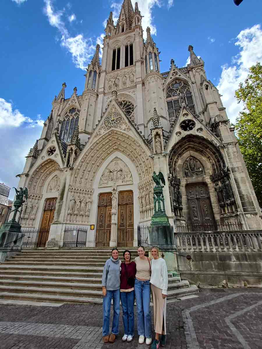 students standing outside of a cathedral