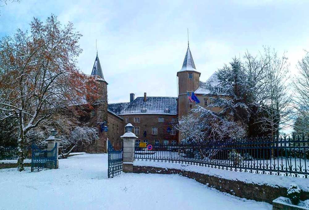 the gated chateau and grounds covered with snow