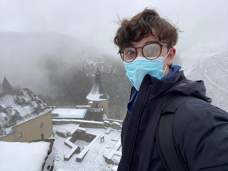 Ethan Kopp wearing a face mask and posing in Luxembourg
