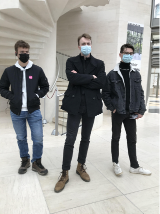 Students wearing masks look at exhibits
