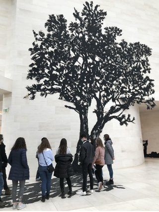 Students looking at the art exhibit The Tree with Indoor Shadow