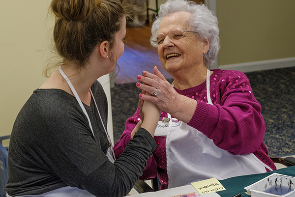 A student and workshop participant exchange high fives
