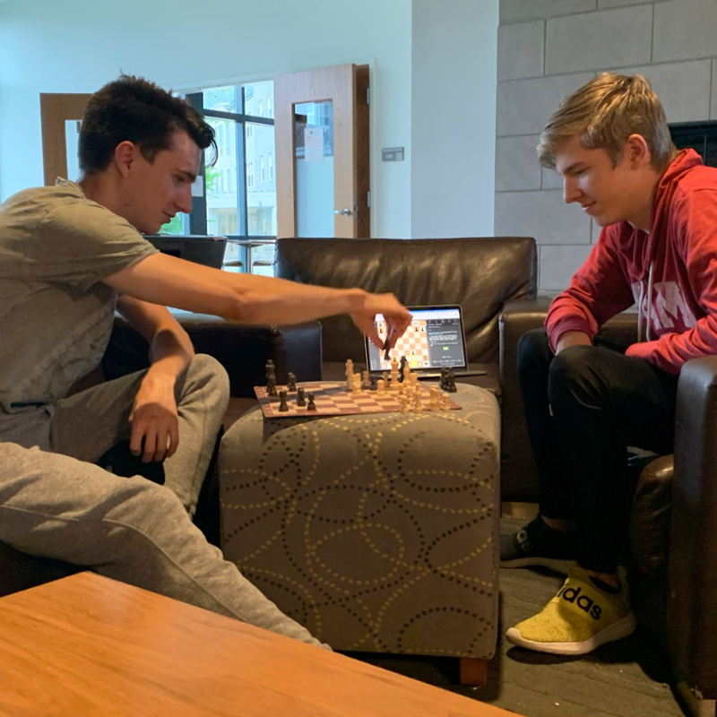 Patrick and a friend playing chess at the residence hall