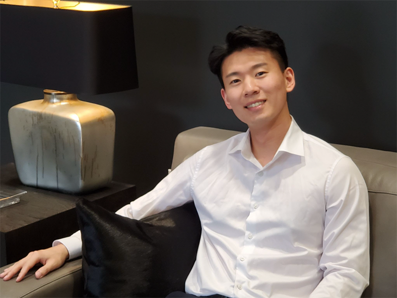 James Heo seated on a couch