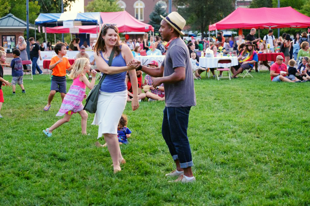Professors Elena and Juan Carlos Albarrán enjoy a dance as children play on the lawn
