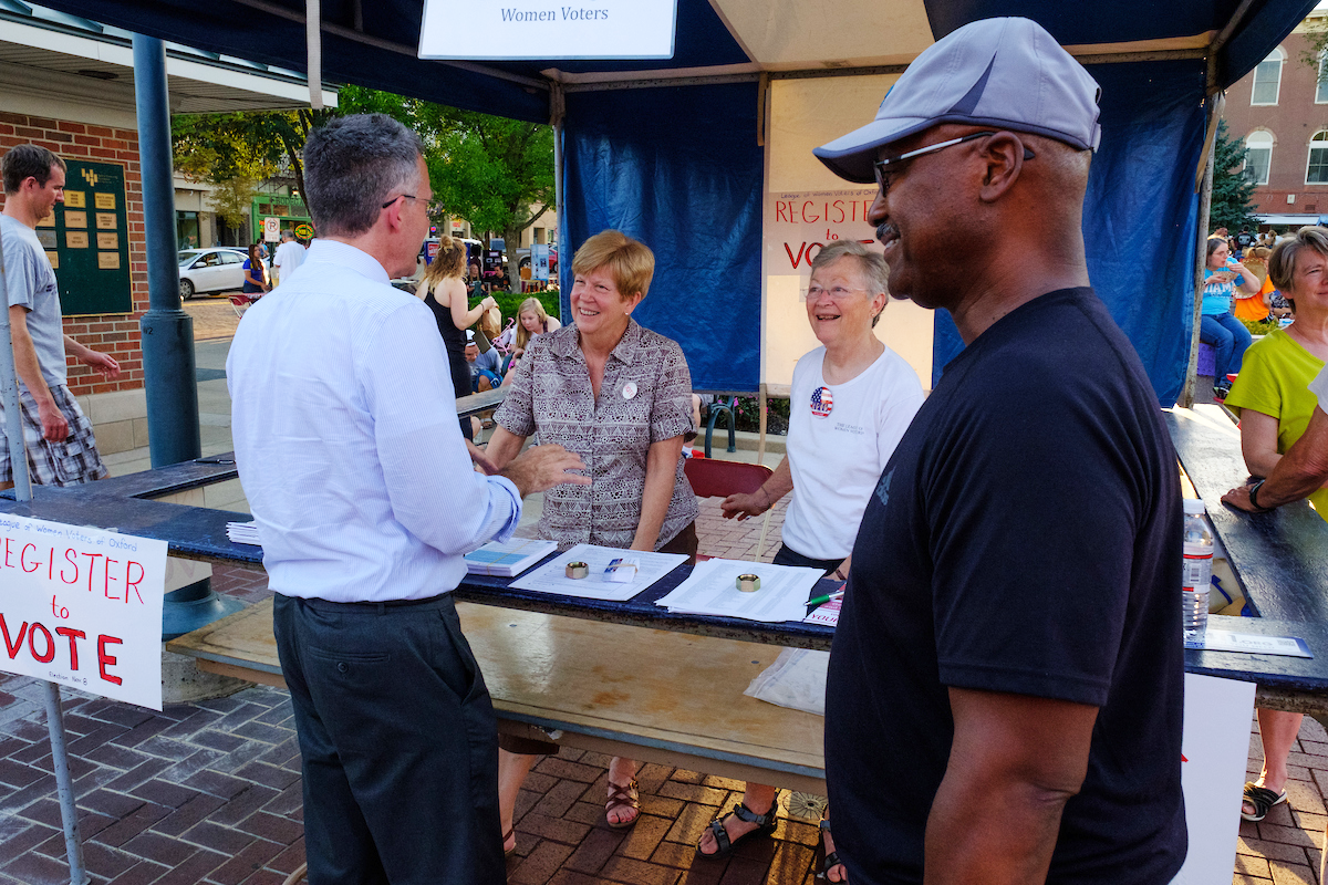 Women at a booth staffed by the Oxford League of Women Voters encouraging people to get out the vote