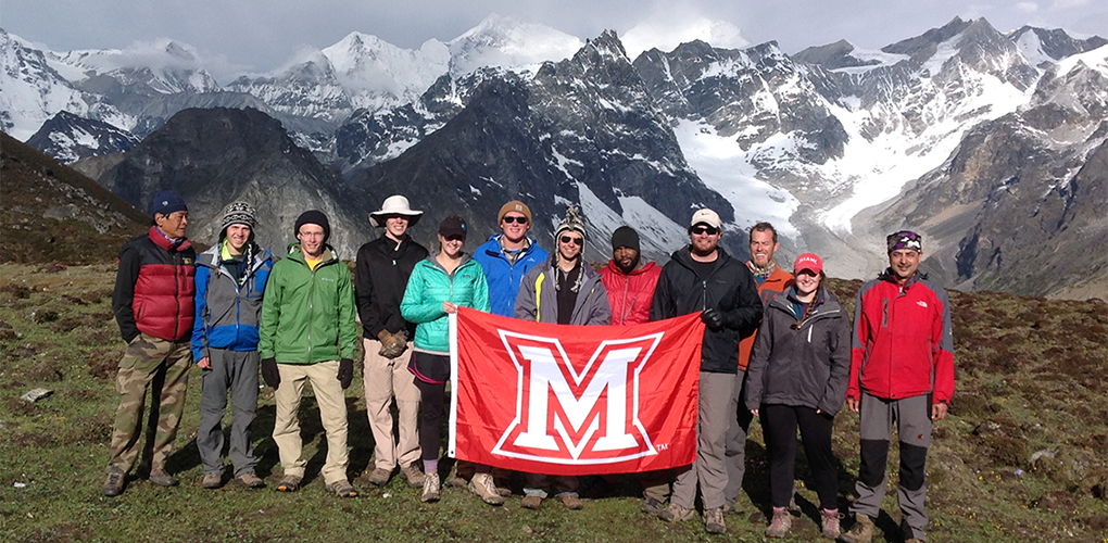 Students in Miami's Life at Altitude faculty-led program pause while hiking in the Himalayas