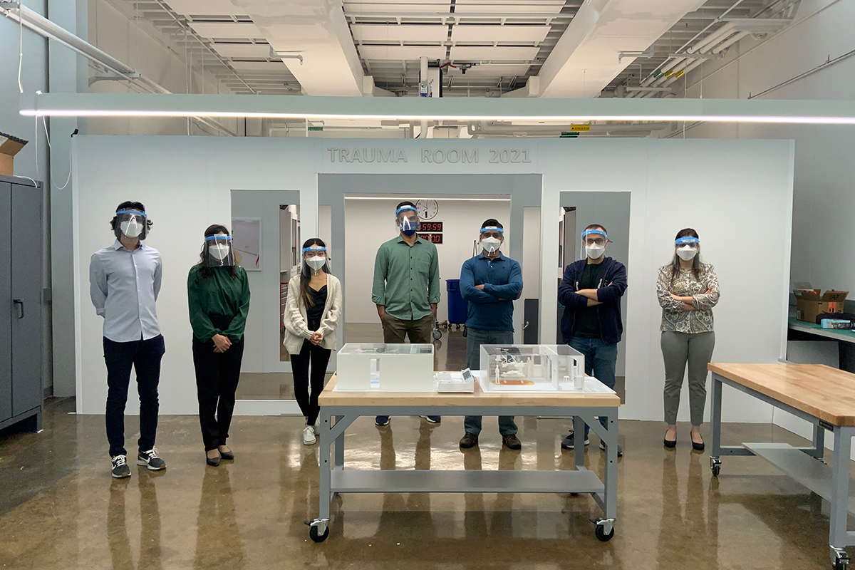 Team stands in a line across the trauma room