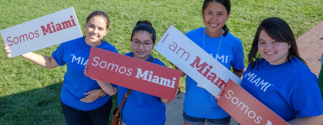 Students hold signs that read 'I am Miami' and 'Somos Miami'