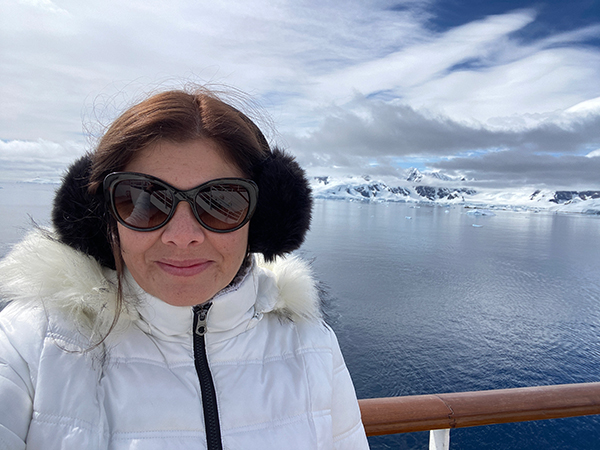 Kimberly Miller, wearing dark goggles and winter apparel, in Antarctica