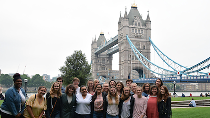 Students in a past Literary London program pose near Tower Bridge
