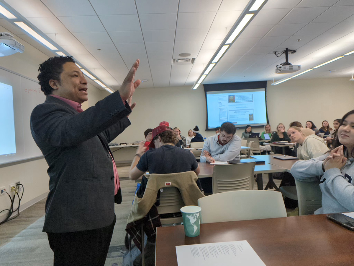 Manuel Iris conducts a writing workshop with Miami students