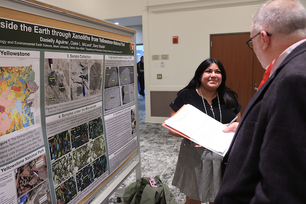 Mike Crowder talking with poster presenter