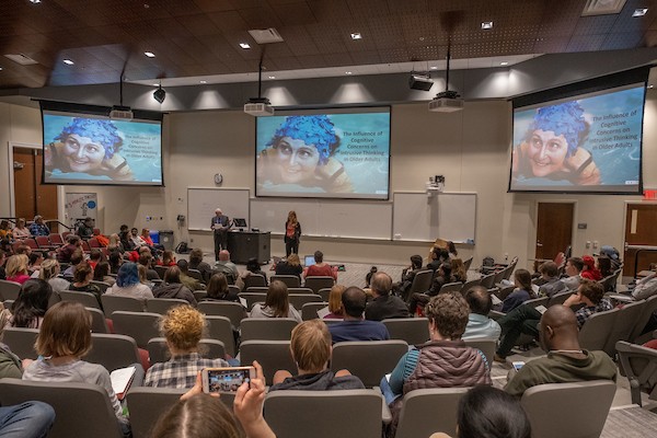 Graduate Students in auditorium during a presentation