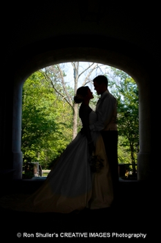 A bride and groom under the Upham Arch.