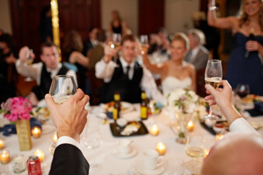 A wedding party raising their glasses for a toast.