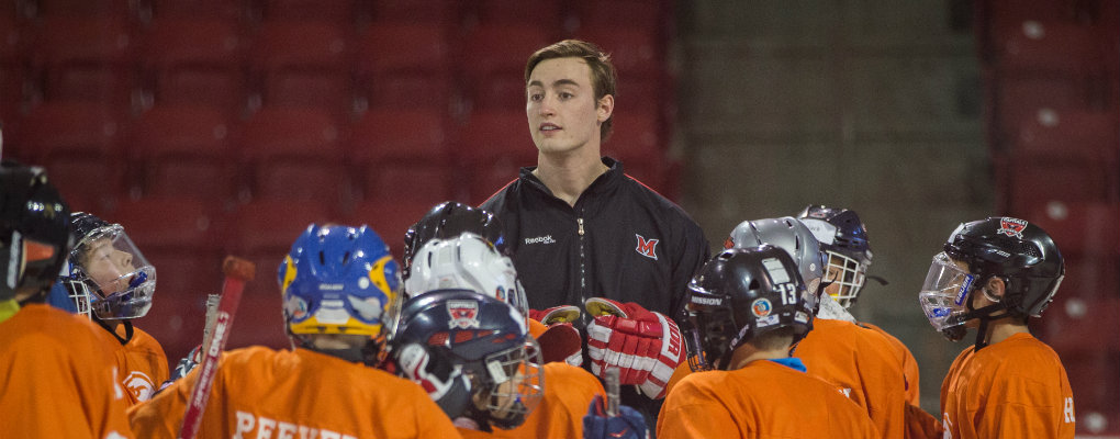 Youth hockey coach talking to team.