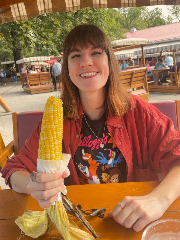 Madison is a graduate HWC consultant. This is a picture of her holding an ear of corn.