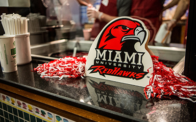 Miami athletics Redhawk logo and spirit gear on counter