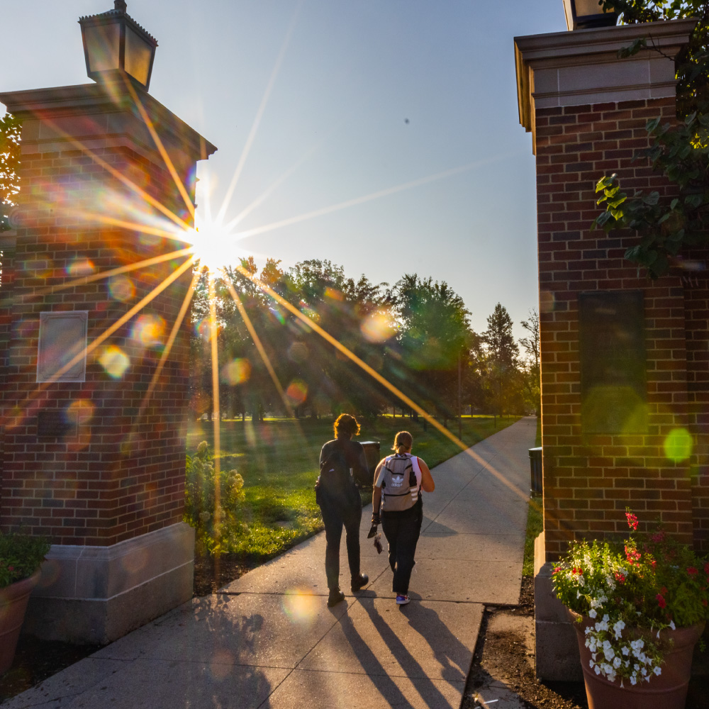 2 students walking through the slant walk on the Oxford campus. 