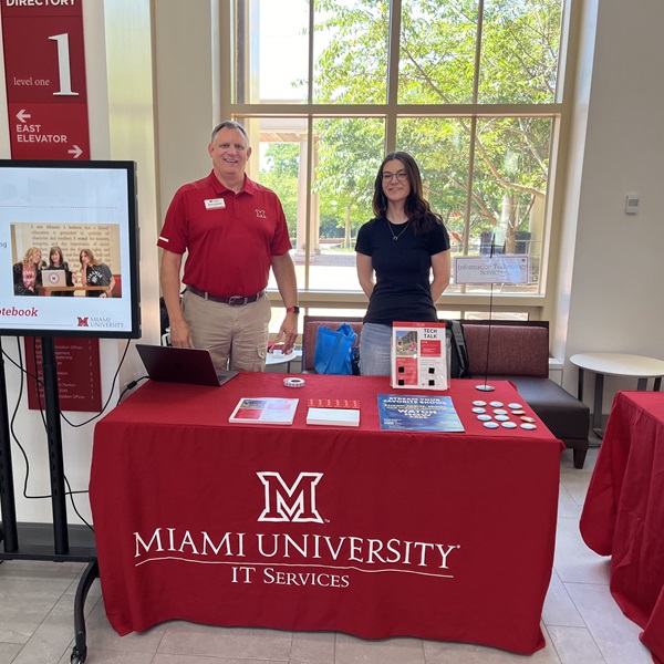 IT Communications staff stands behind the IT table at the Orientation Resource Fair