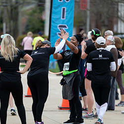 Race participants high five each other