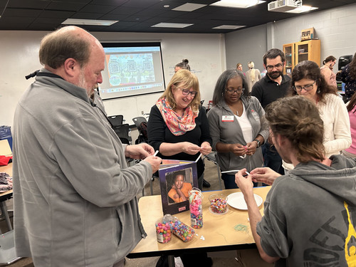 IT Services folks participate in art activities while directed by students