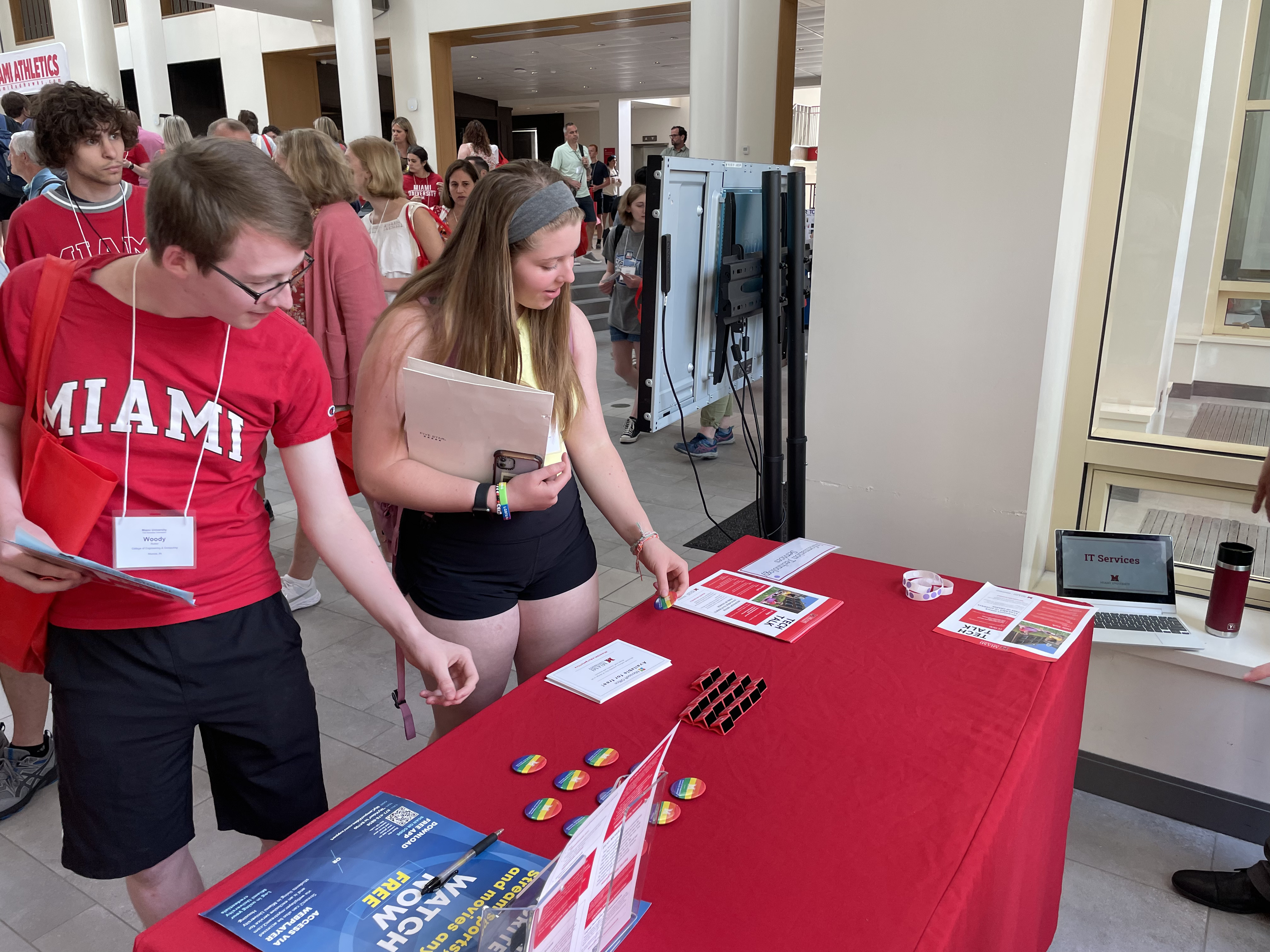 Two incoming students standing and looking at resource fair table