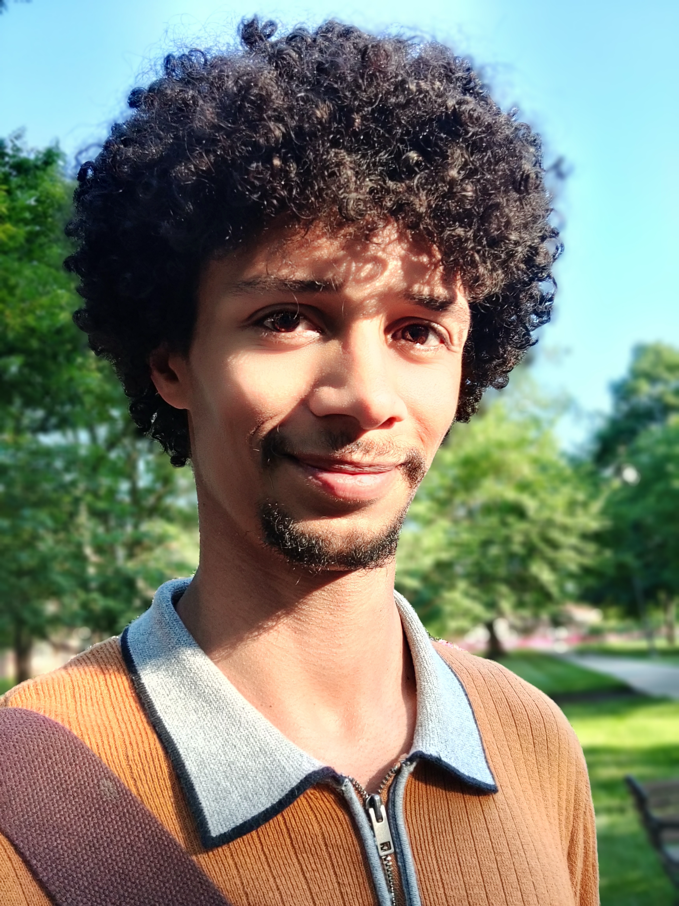 Close-up of Zacchary smiling in the sunlight