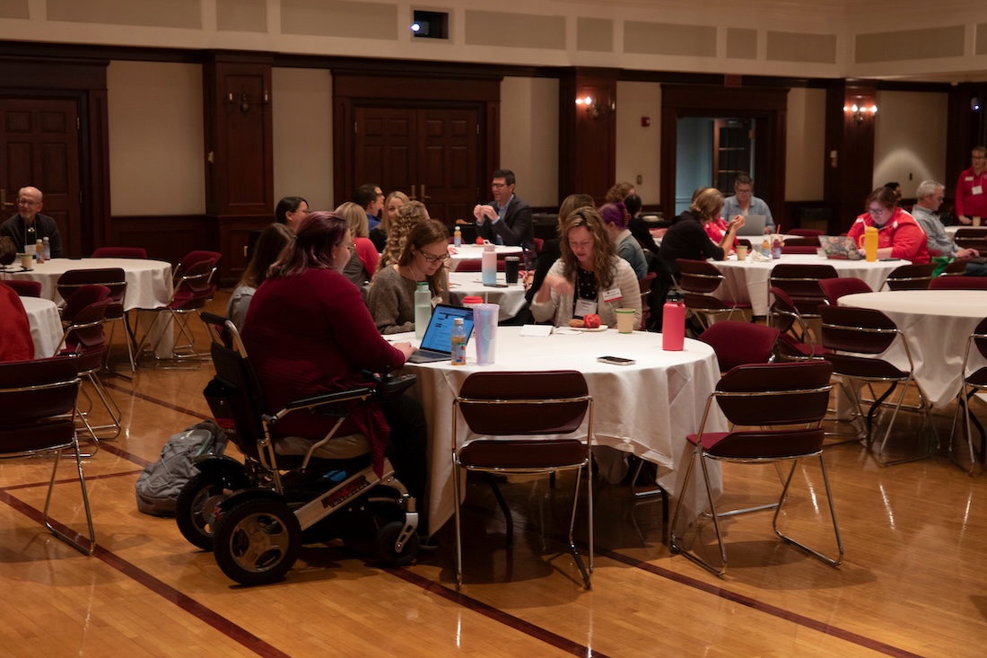 Attendees sitting at tables during the 2023 Accessibility Symposium in the Heritage Room of the Shriver Center