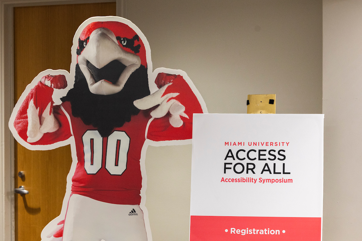 A cardboard standup of Swoop next to a sign that says Access for All