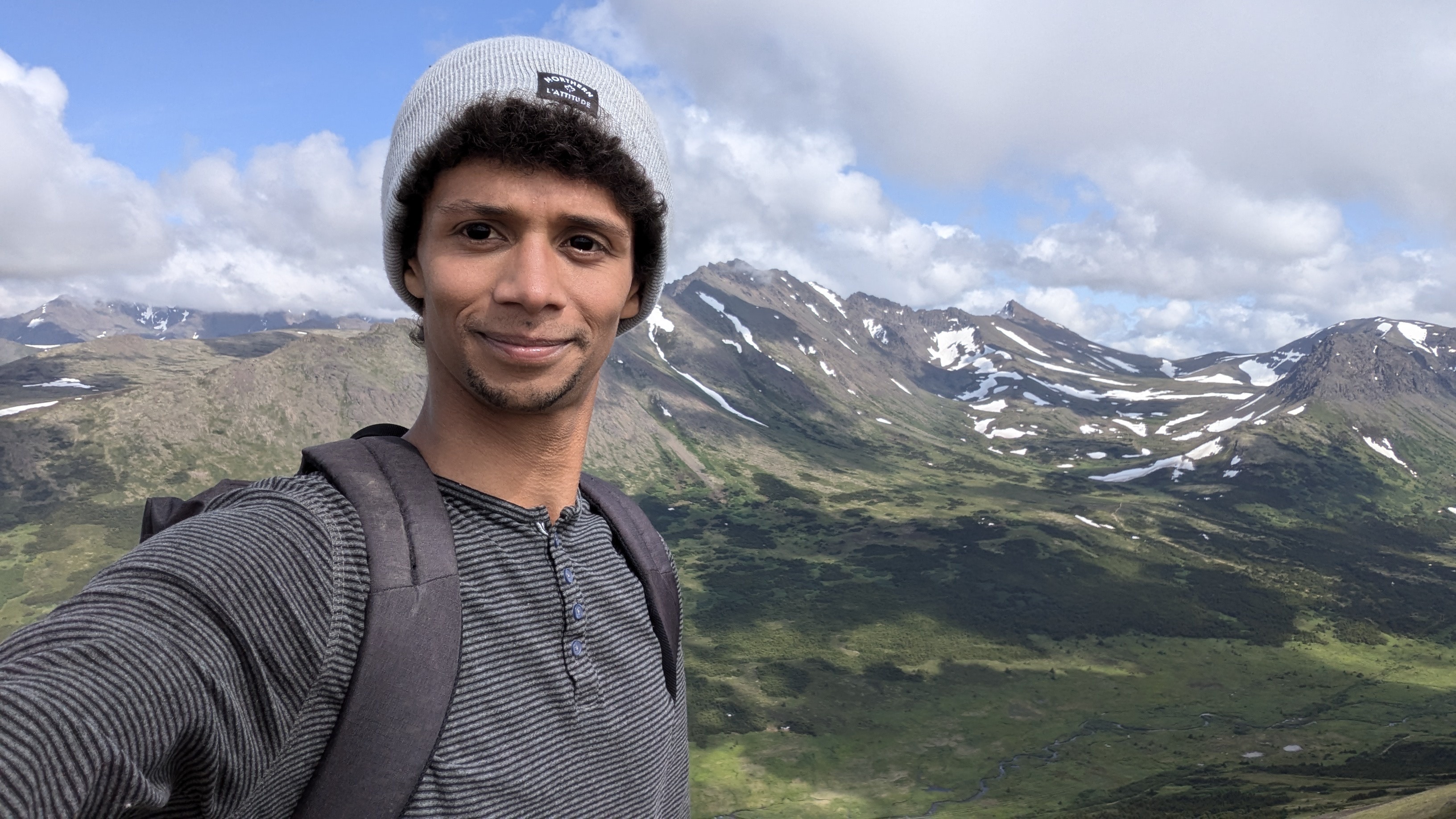 Selfie of Zacchary in front of alaskan mountains
