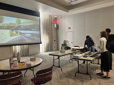 People playing a car racing game with accessible controllers
