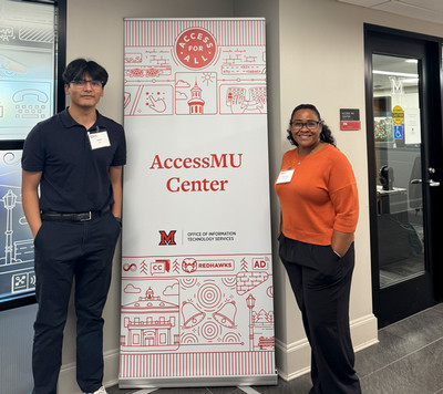 Sid Karki and Belinda Worley standing in front of the AccessMU banner outside the center