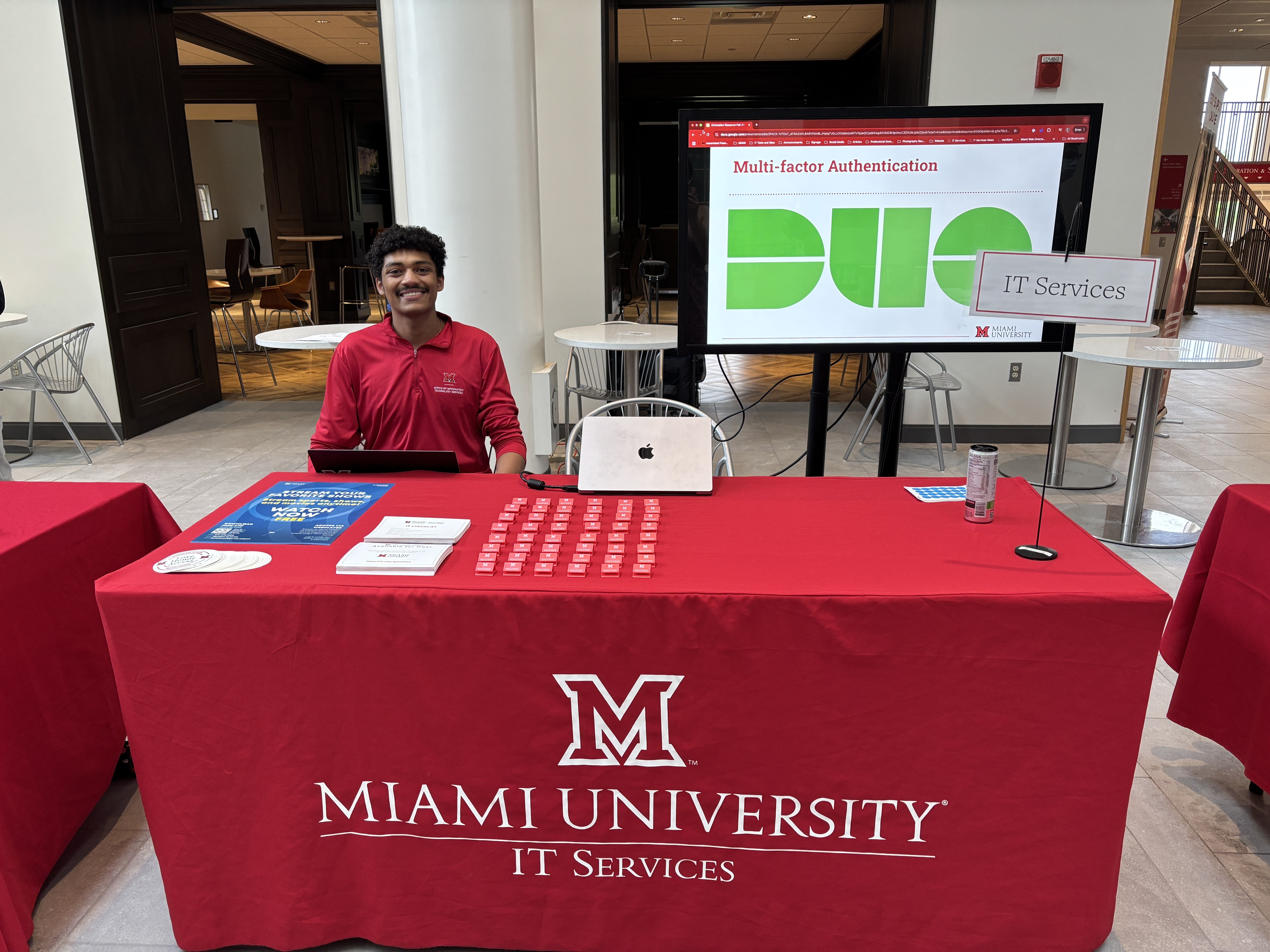 Skylar Hamilton sits at the IT Services table at the Orientation Resource Fair