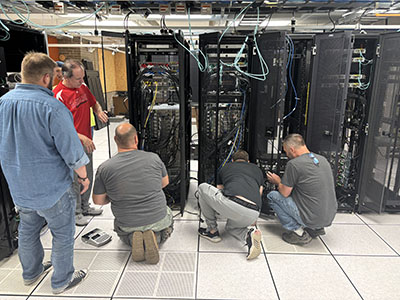 The network services and network infrastructure teams working in the data center to rotate the HPC
