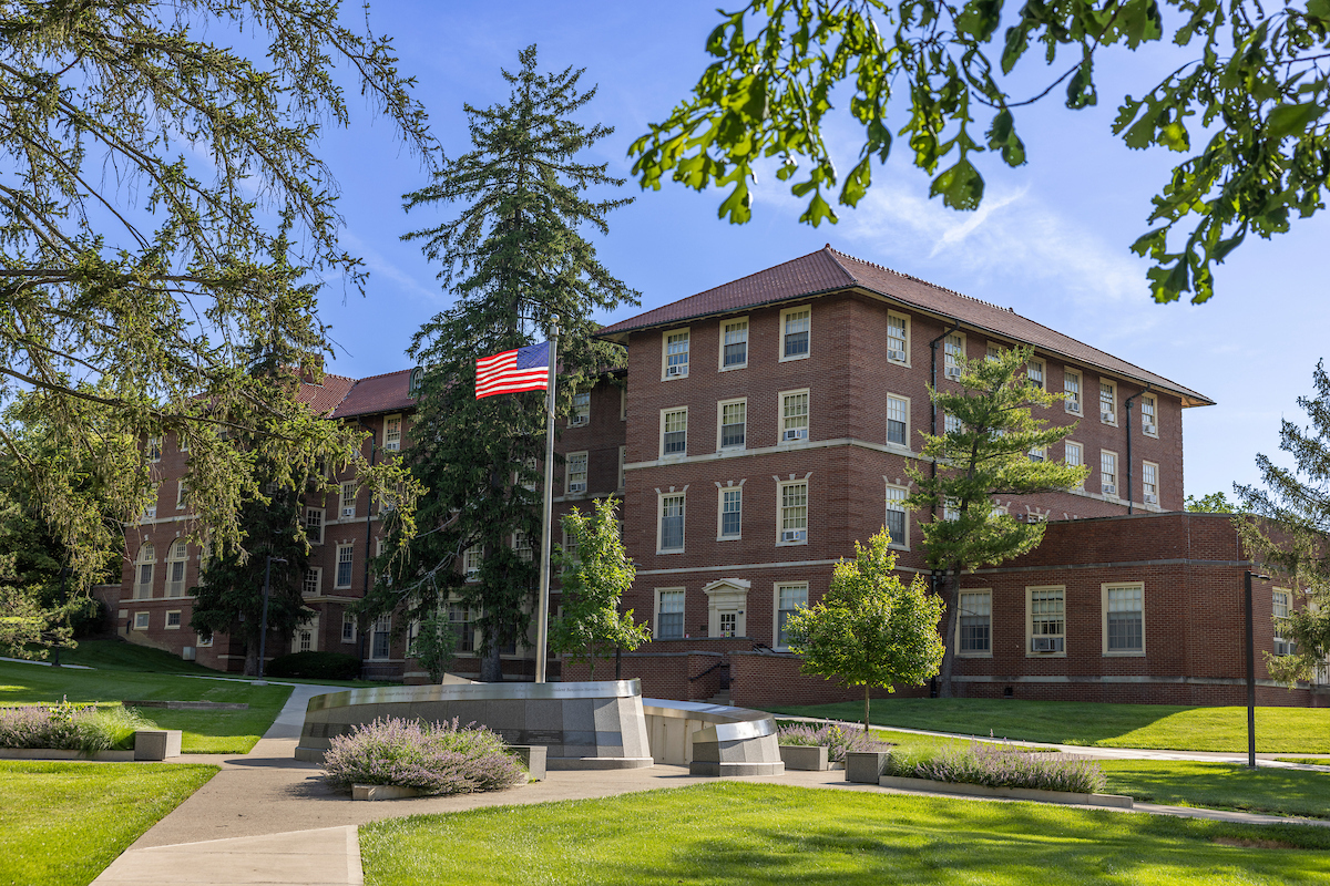 The American Flag waving over the Veterans Memorial on the Oxford campus