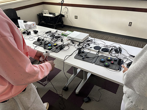 A person using accessible gaming controllers