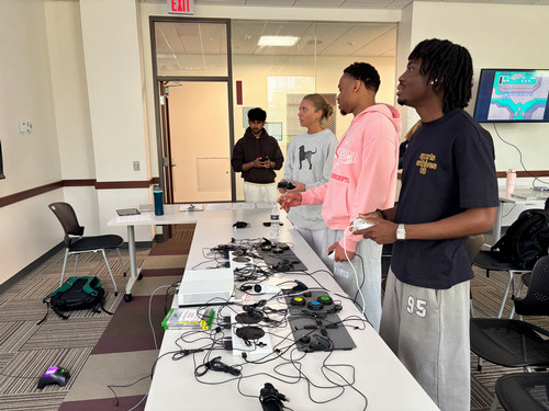 People using adaptive controllers at Miami's accessible gaming event