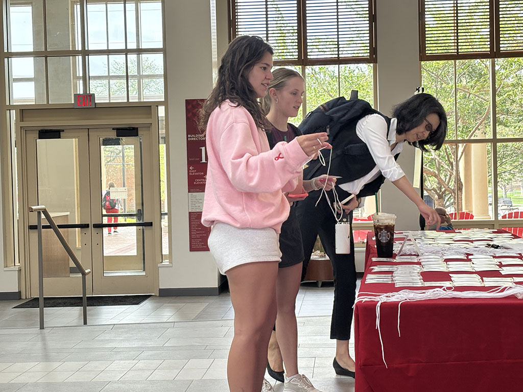 Students and staff check in at the main table for the AI Symposium