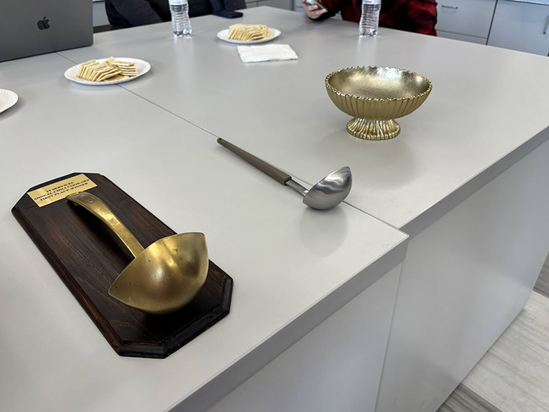 The first place, second place, and people's choice trophies for the chili competition