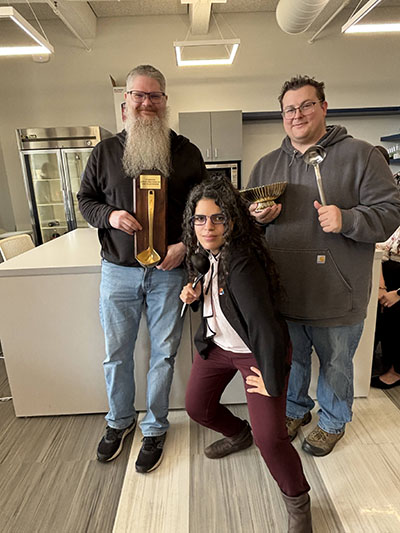 Patrick Hawk, Joe Mills, and Sofia Olaya at the chili competition