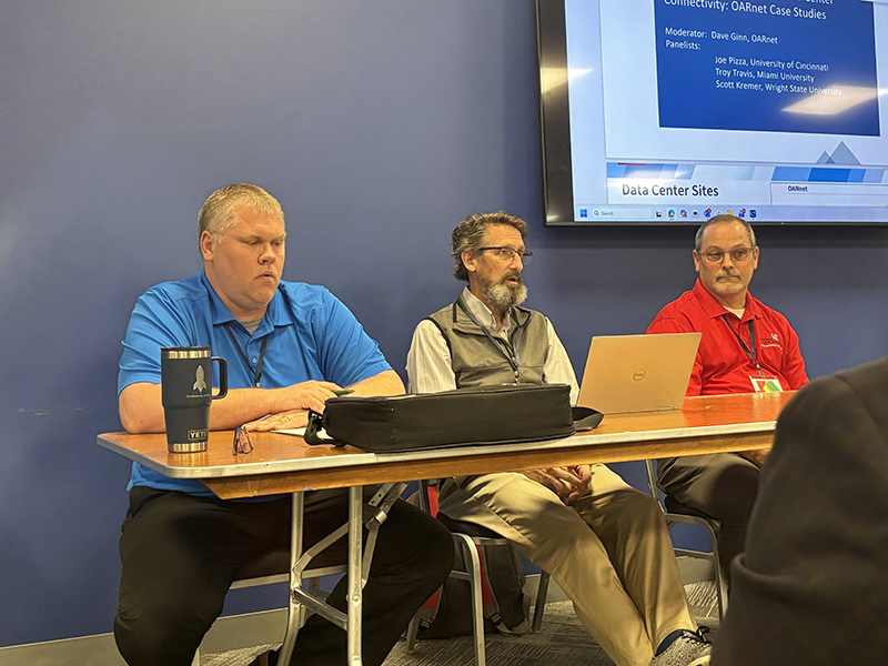 Troy Travis and two others sit on a panel about data center infrastructure at the conference
