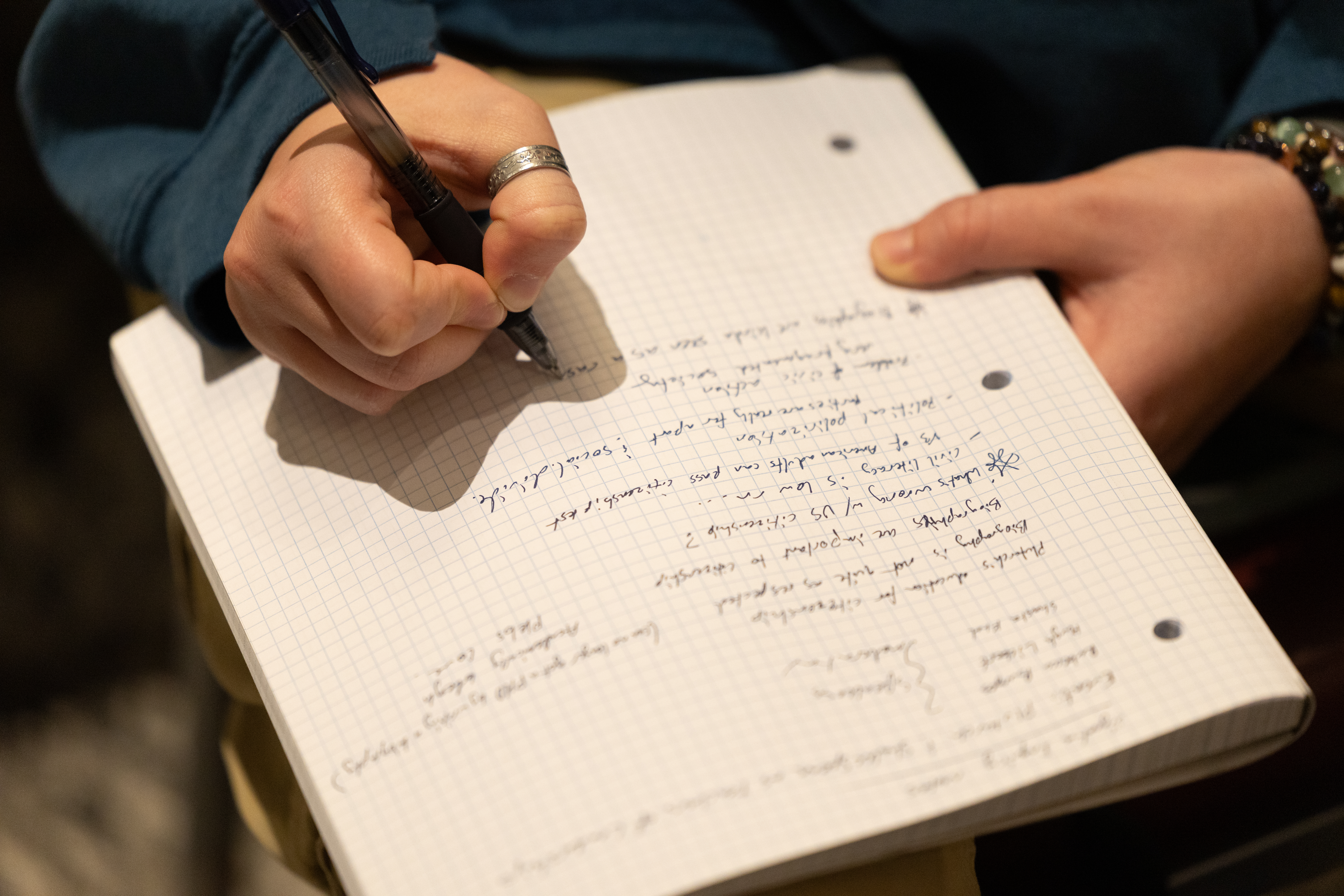 A person writing in a notebook.