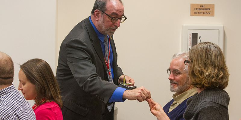Scott Lissner distributes item to attendees