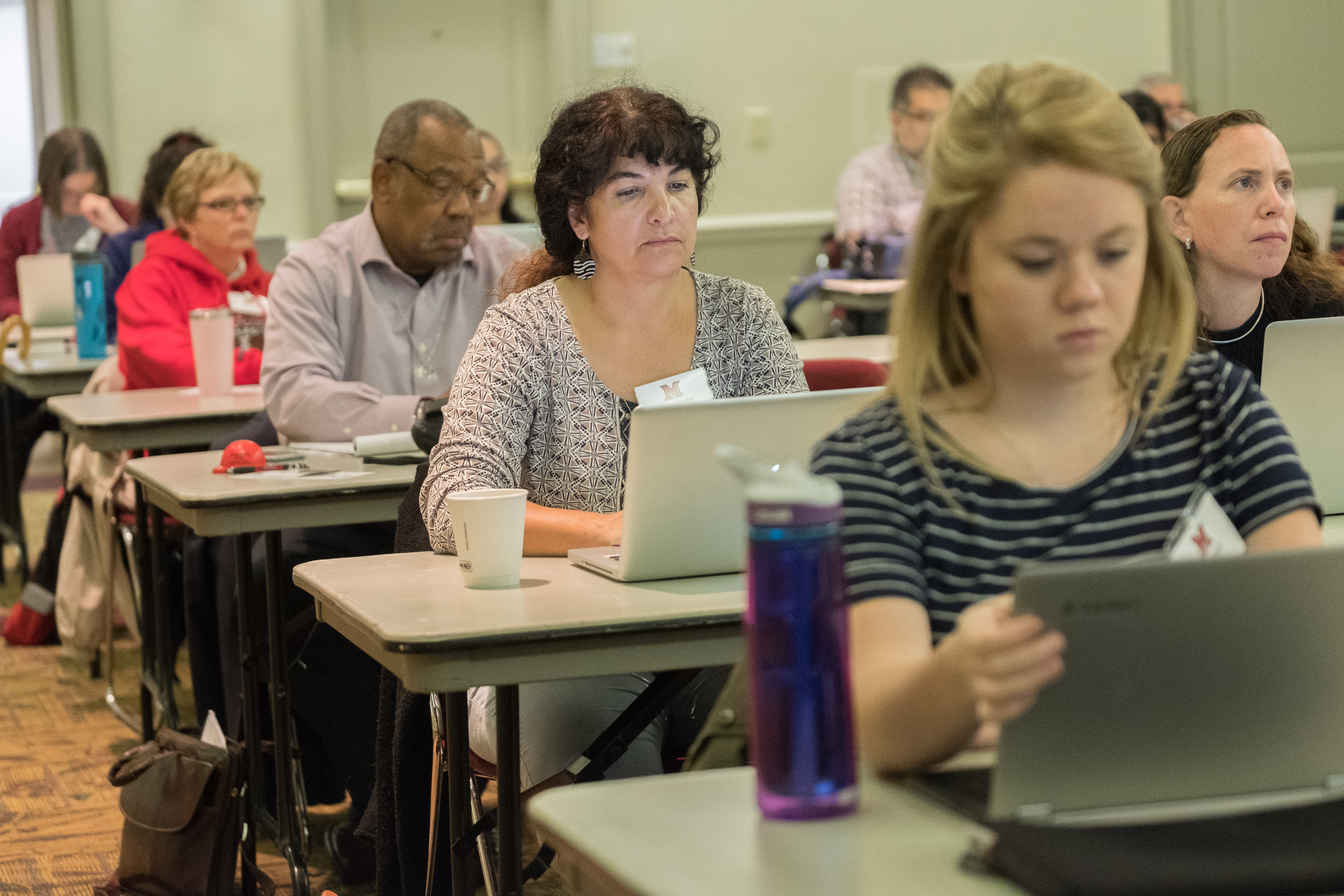 Attendees watch as Cyndi Govreau and Elizabeth Farrer present.
