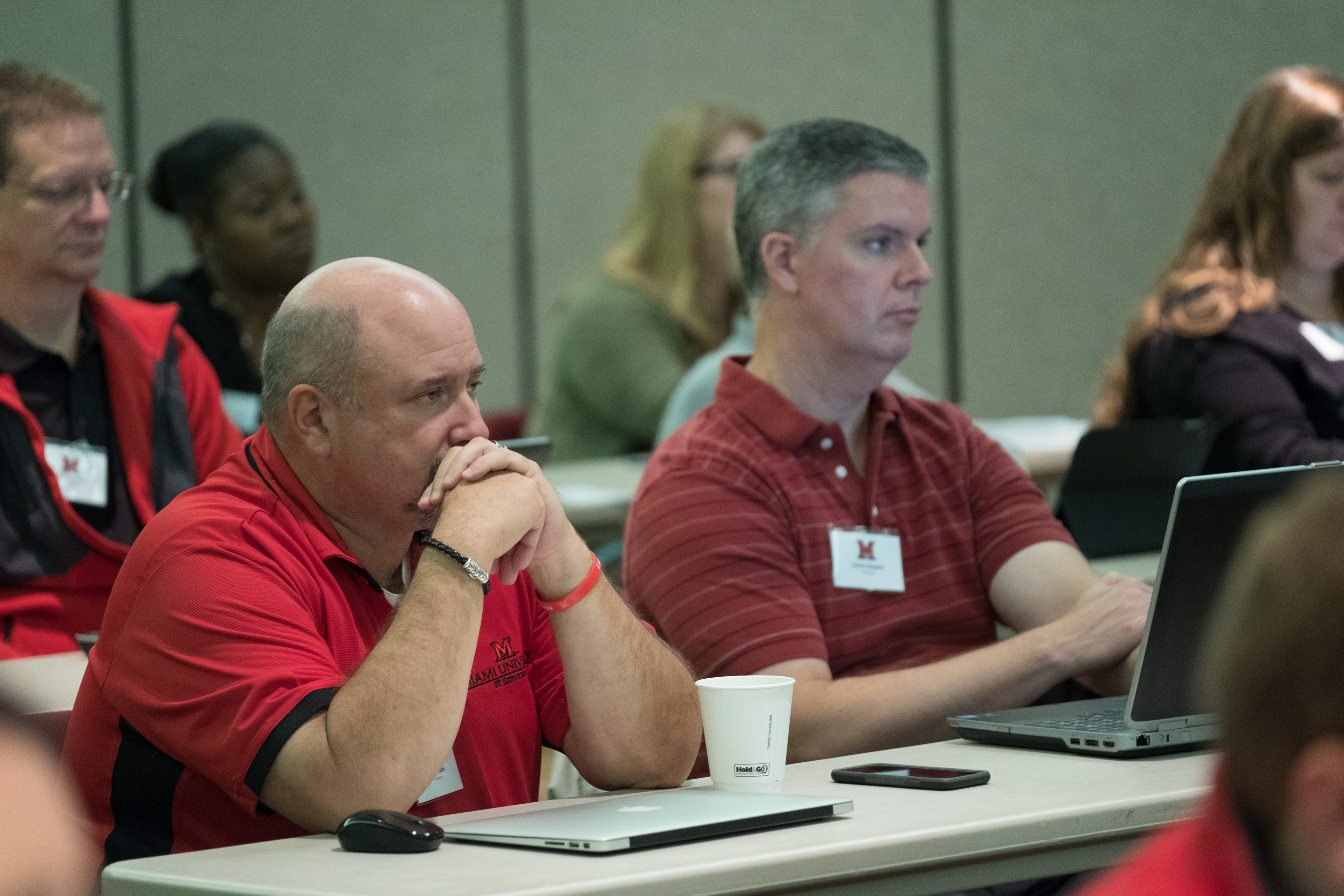 A group of attendees watch Kara Zirkle present at the AT Symposium.